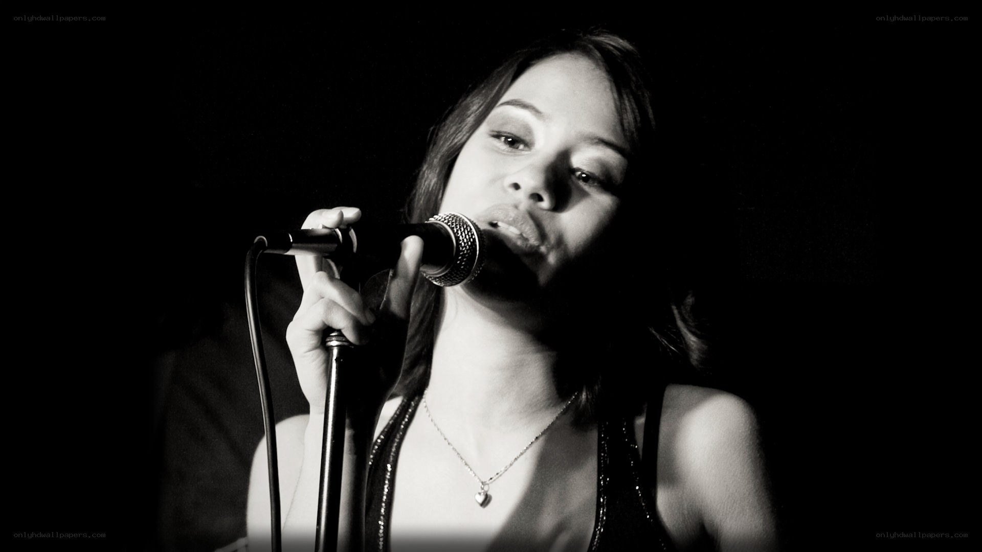 woman singing into microphone