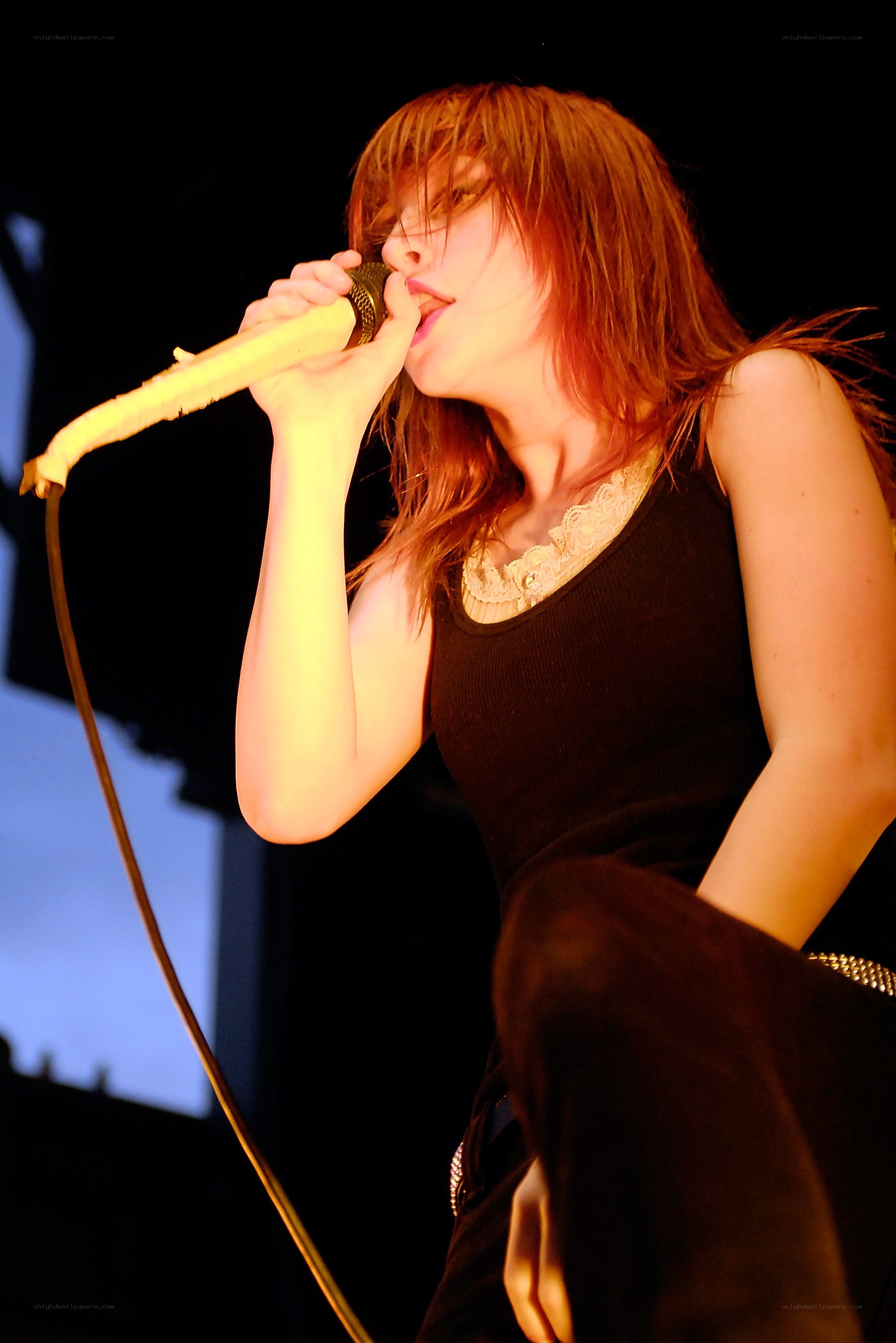 woman singing into microphone