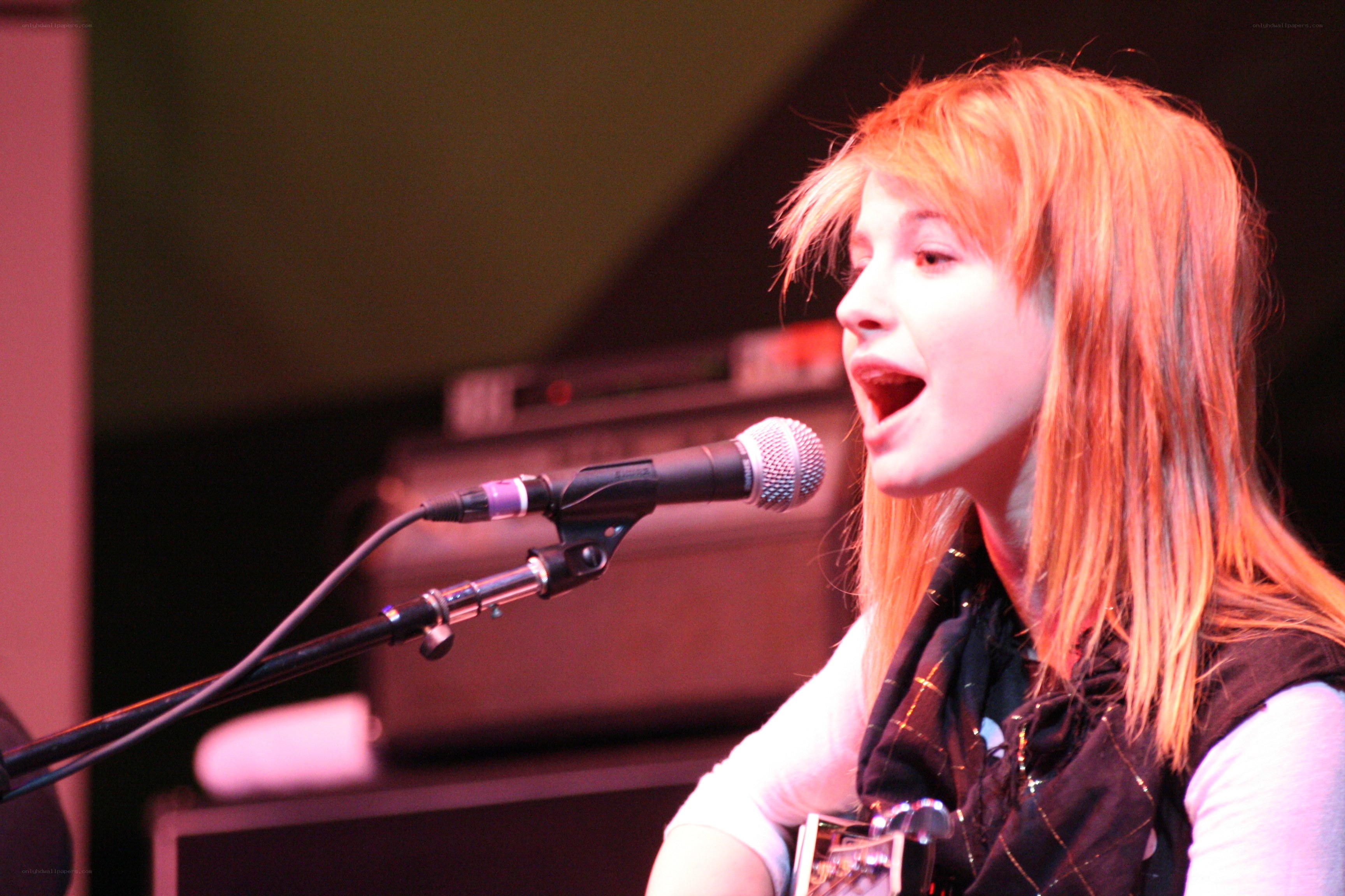 woman singing into microphone