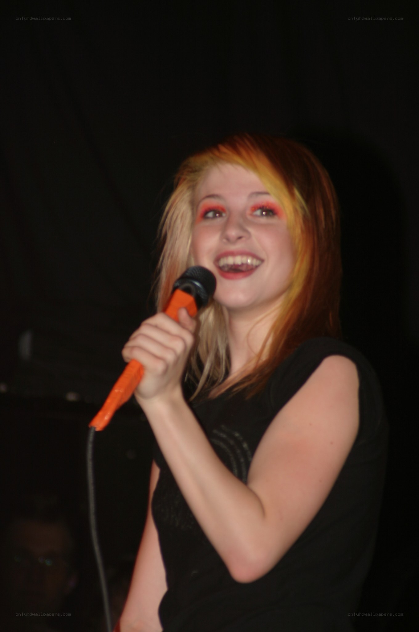 woman singing into microphone