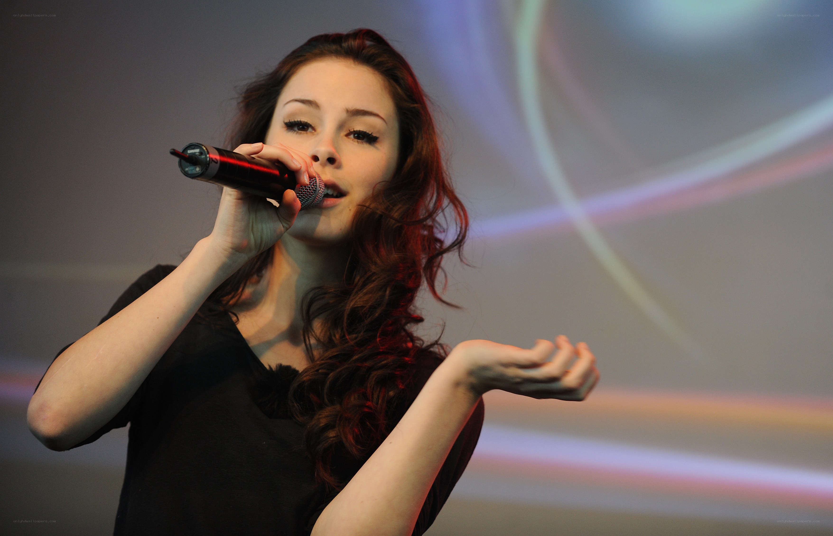 woman singing into microphone