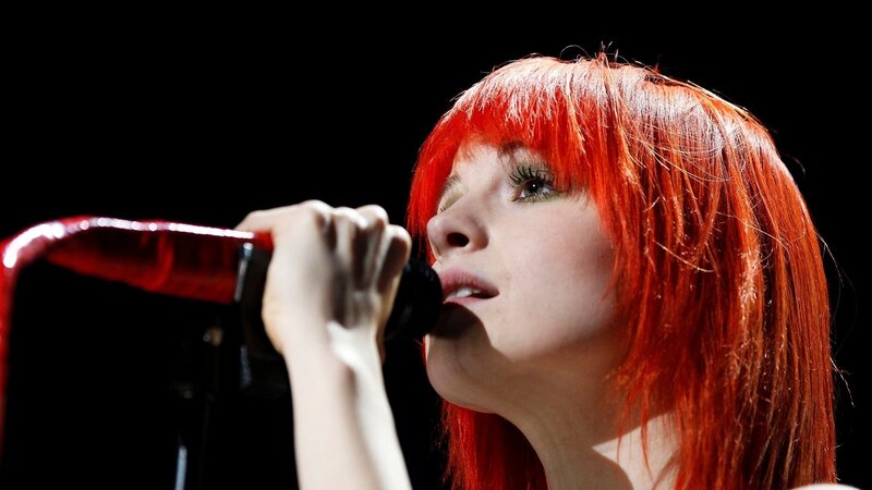 woman singing into microphone