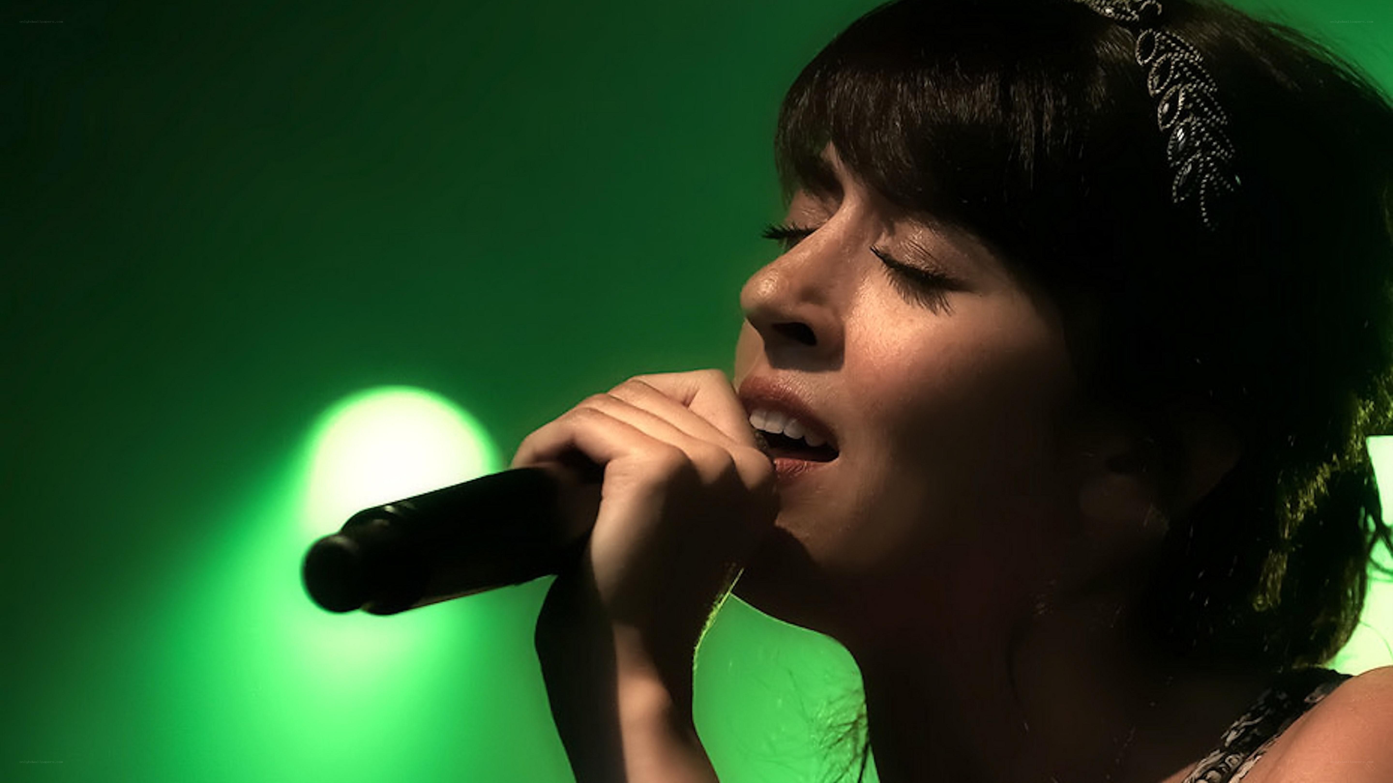 woman singing into microphone