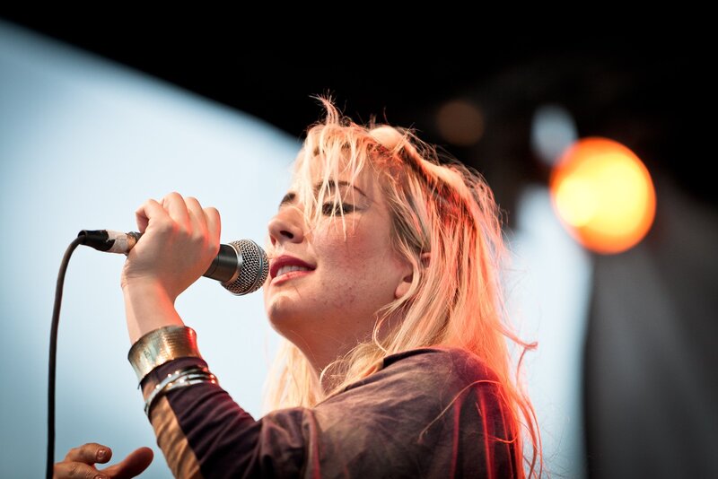 woman singing into microphone