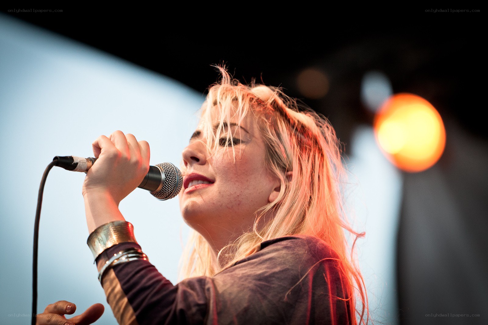 woman singing into microphone