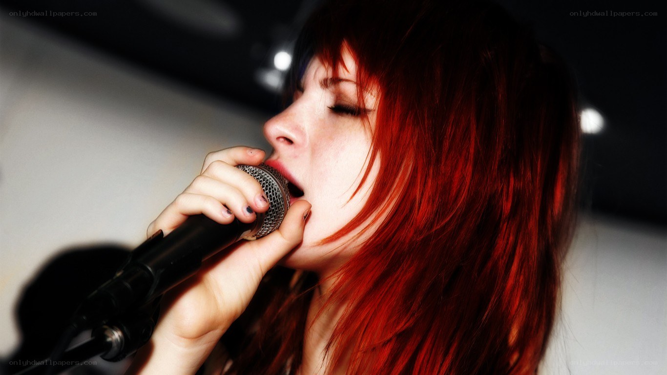 woman singing into microphone
