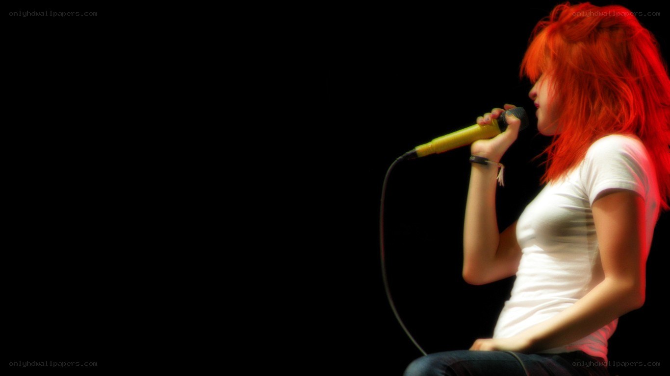 woman singing into microphone