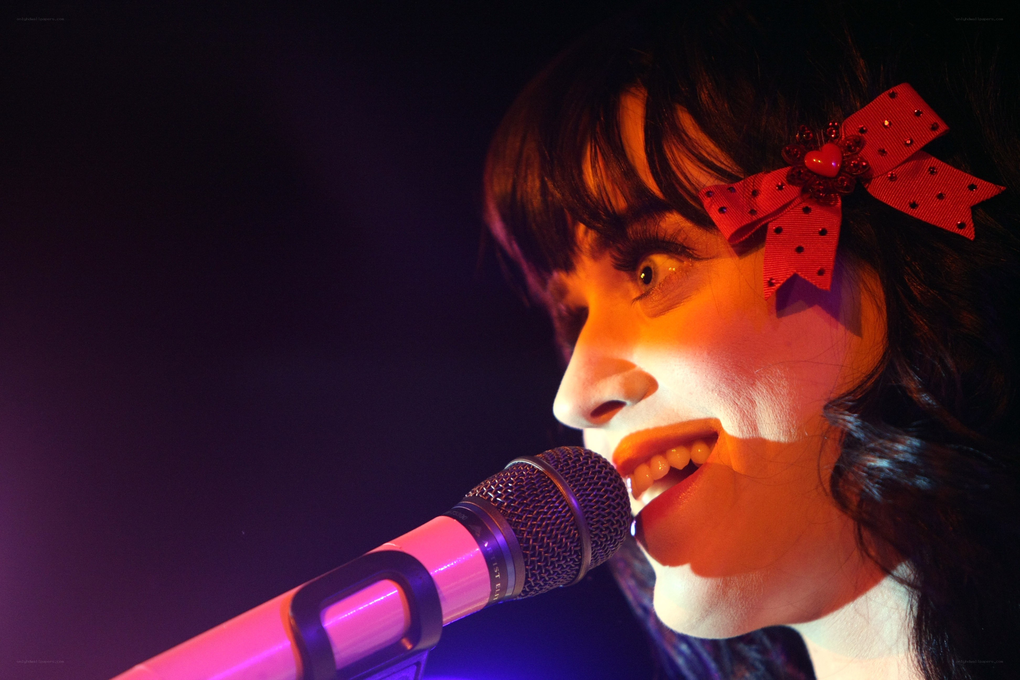 woman singing into microphone