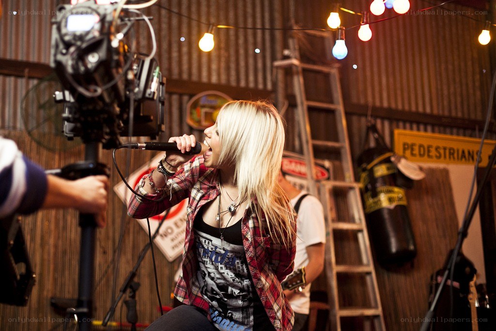 Woman singing into microphone