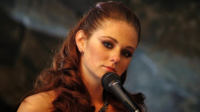 woman singing into microphone