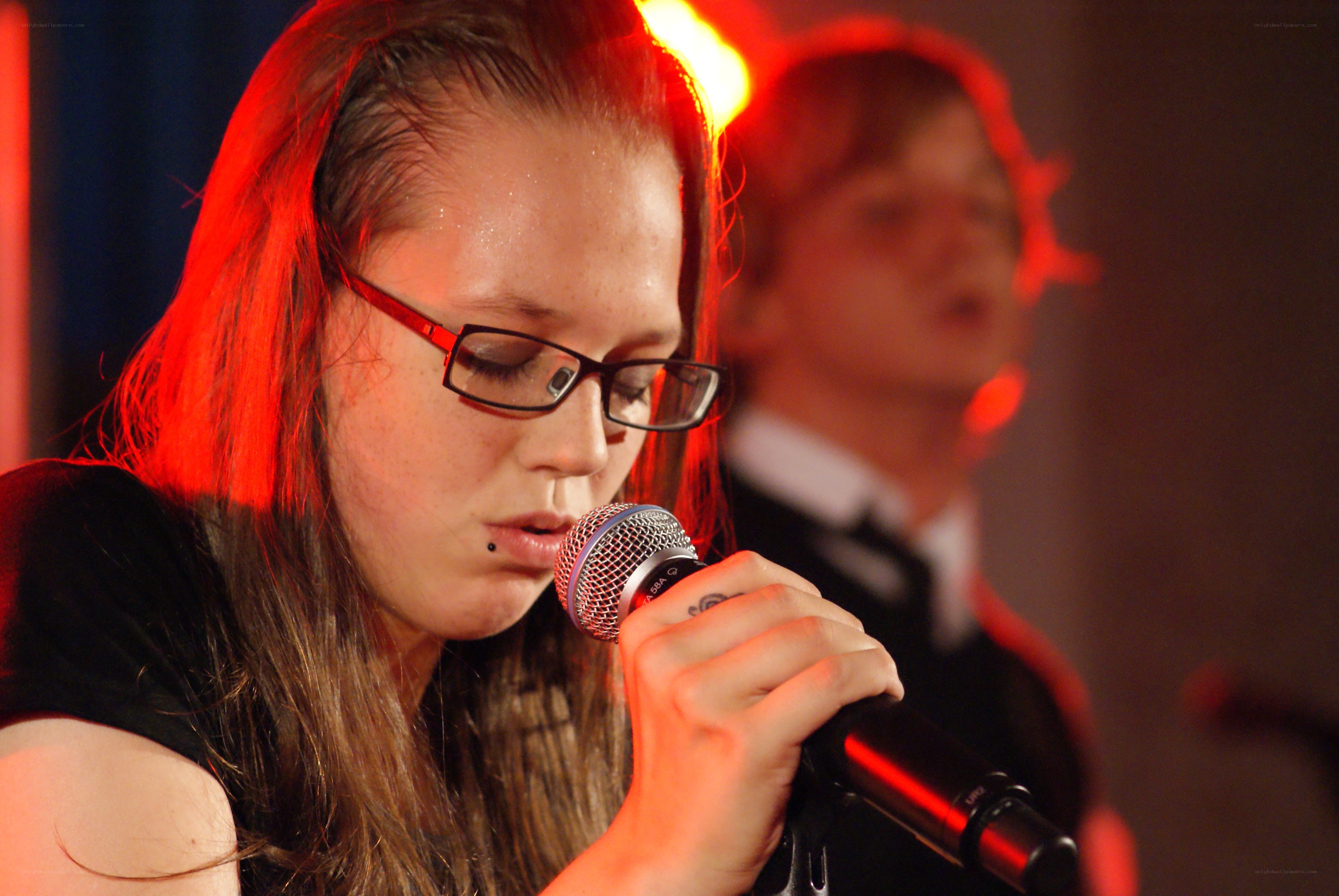woman singing into microphone
