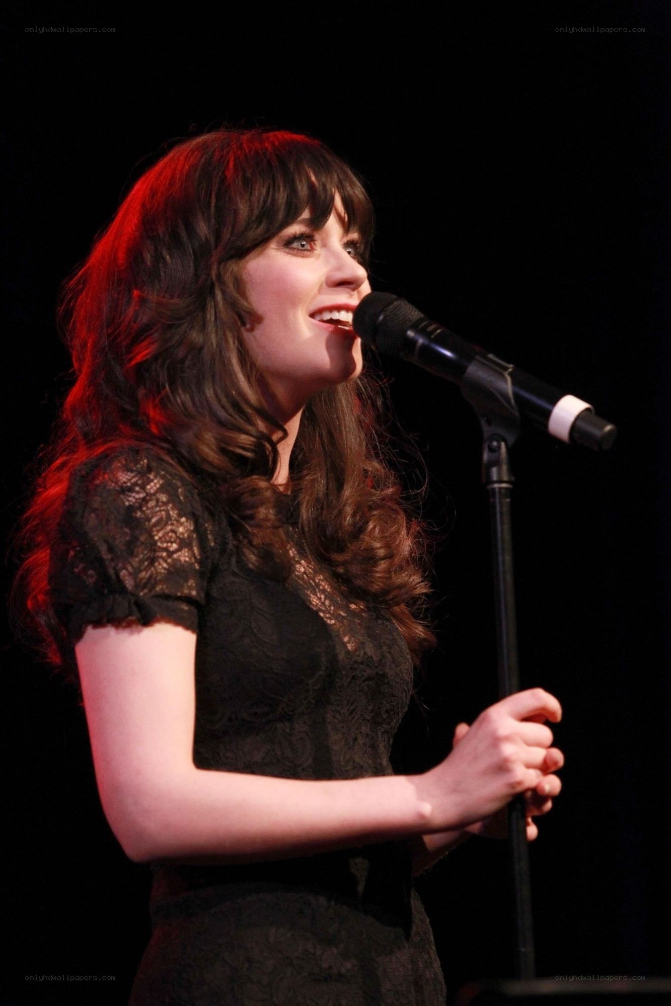 woman singing into microphone