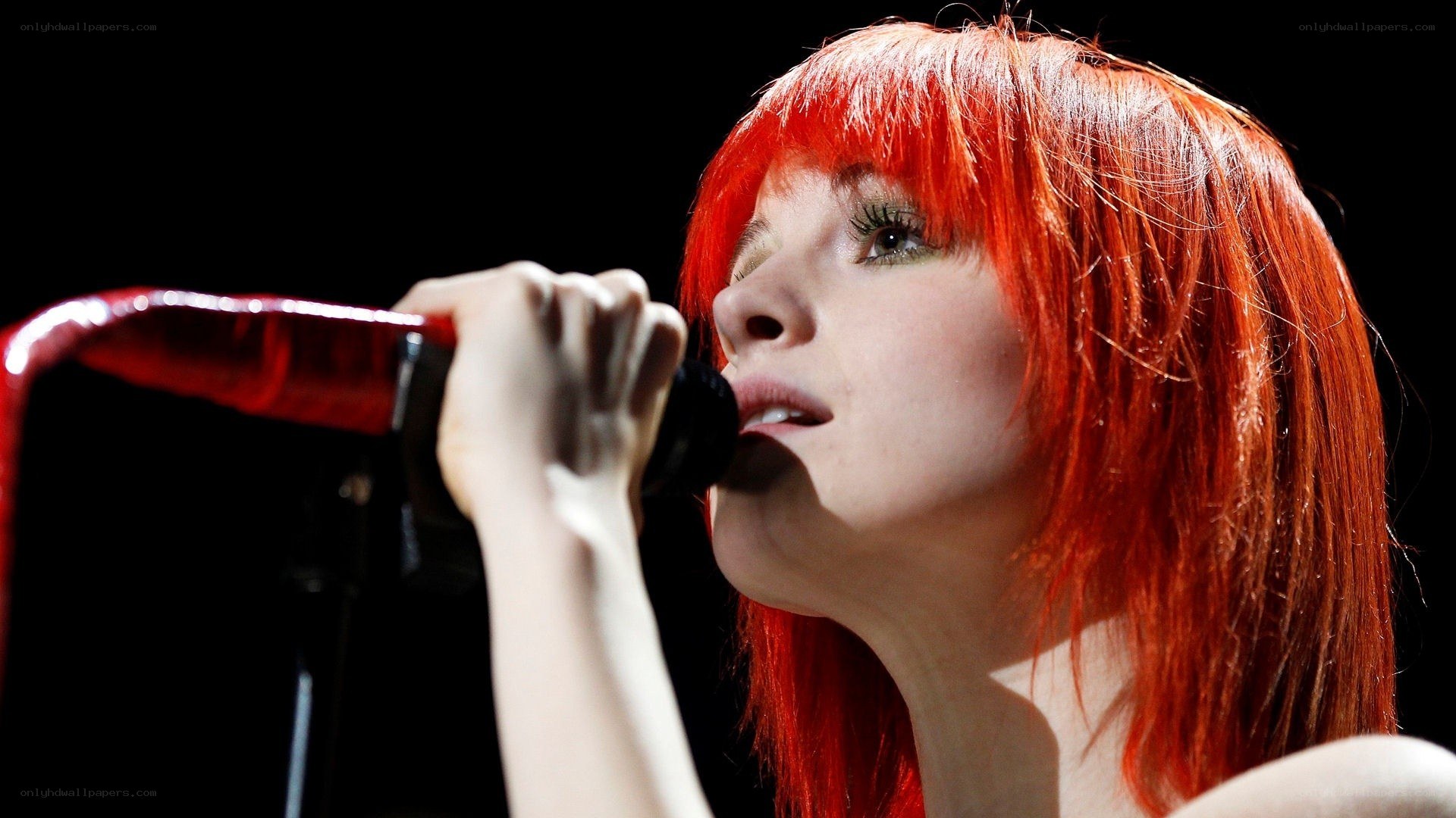 woman singing into microphone