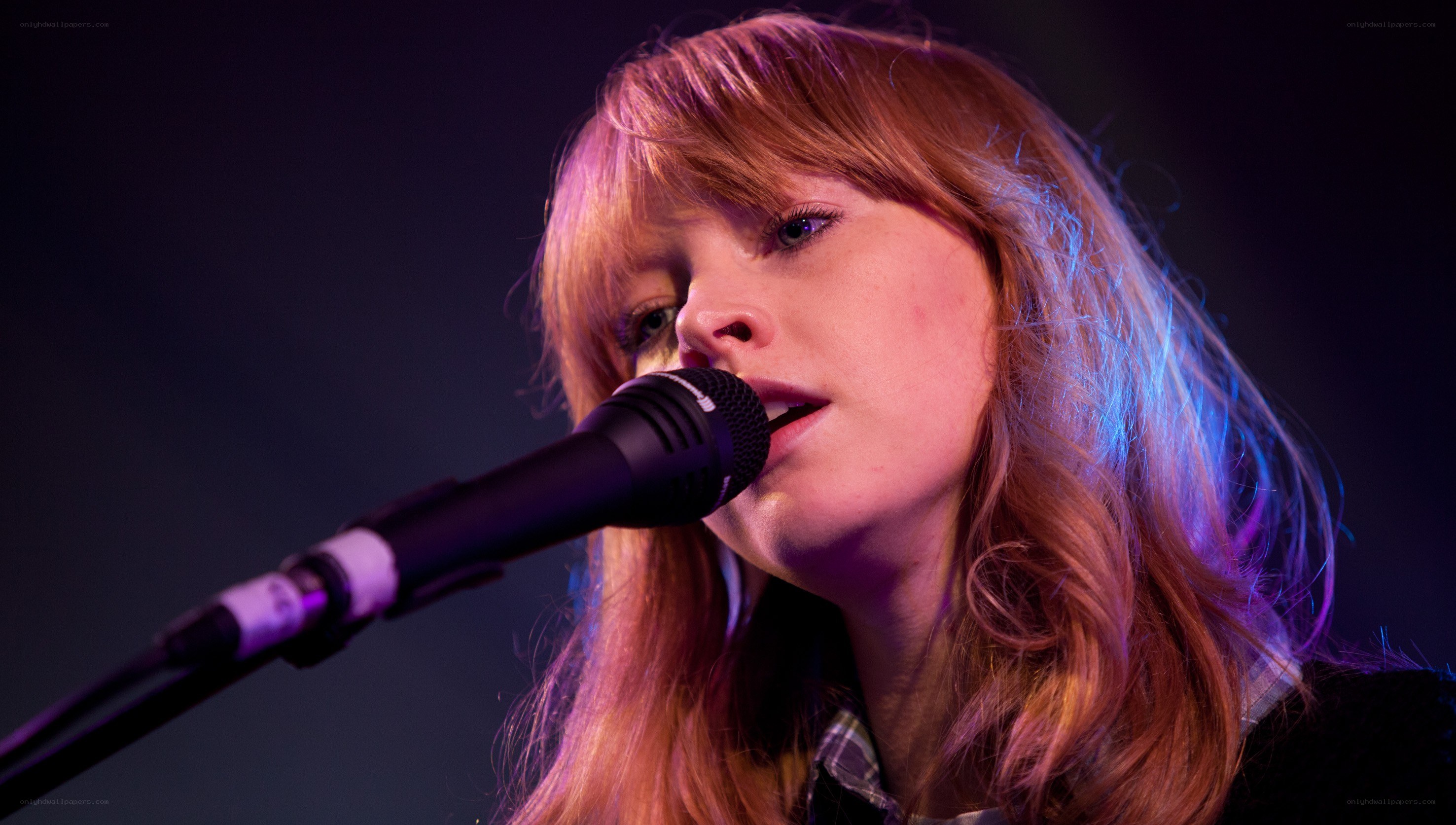woman singing into microphone