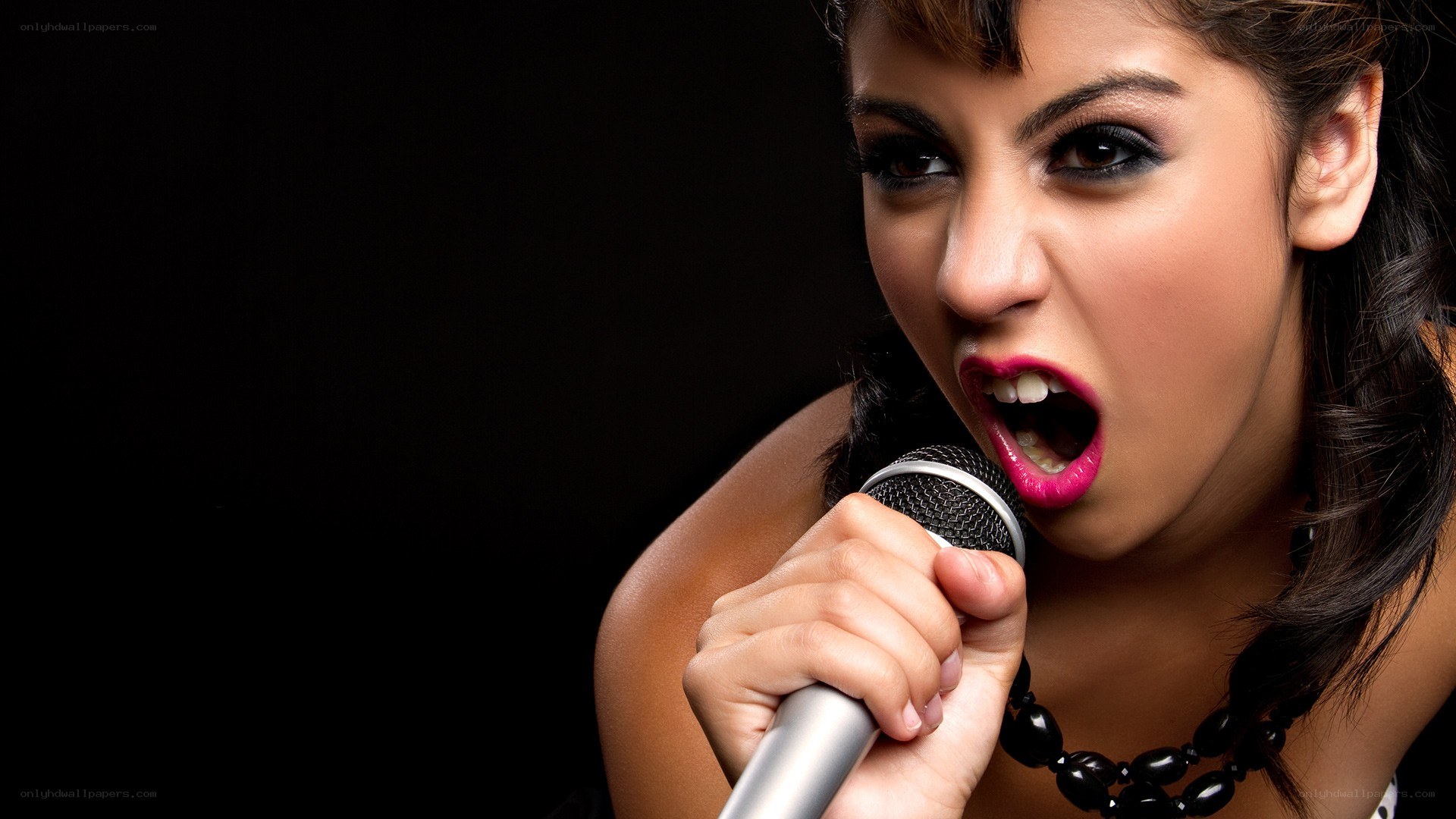 woman singing into microphone