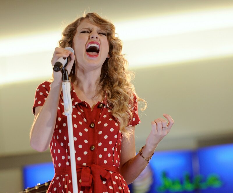 woman singing into microphone