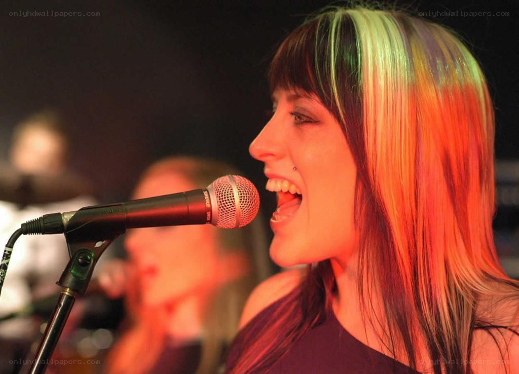 woman singing into microphone