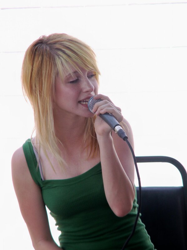 woman singing into microphone