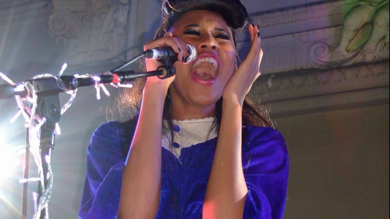 woman singing into microphone