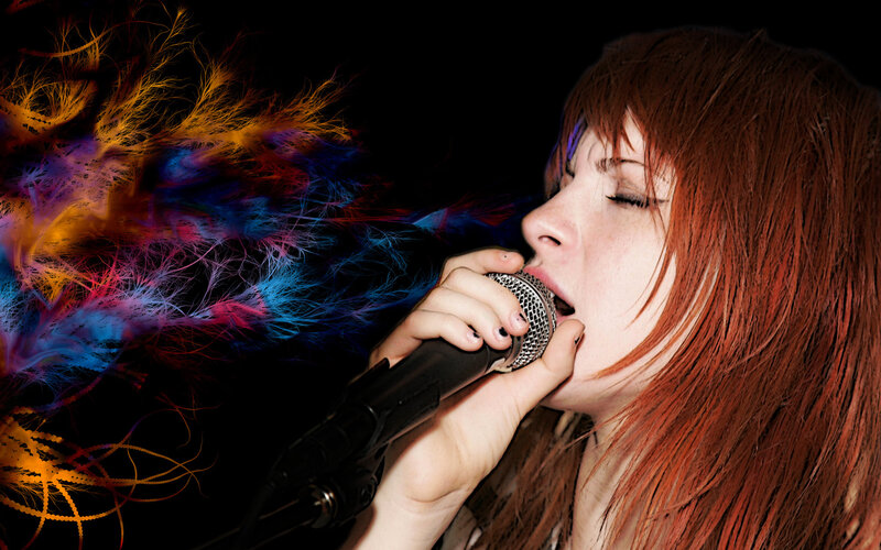 woman singing into microphone