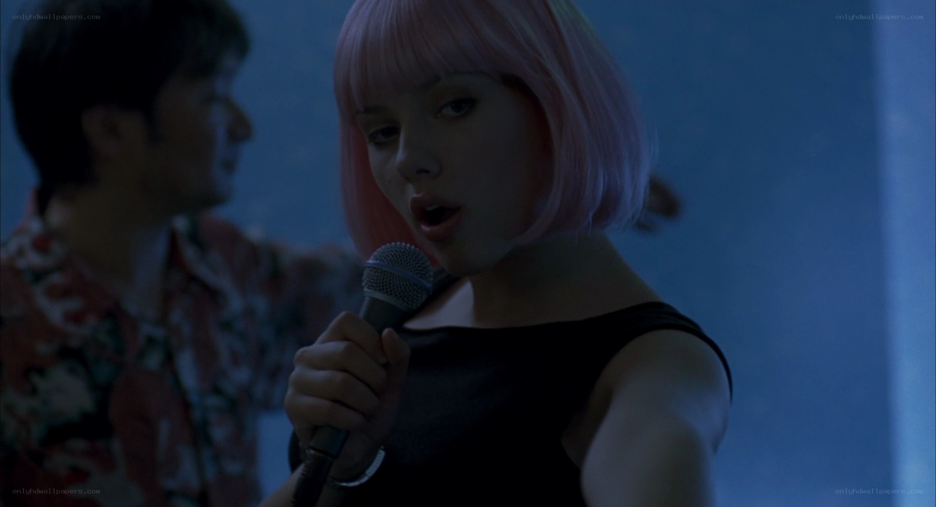 woman singing into microphone