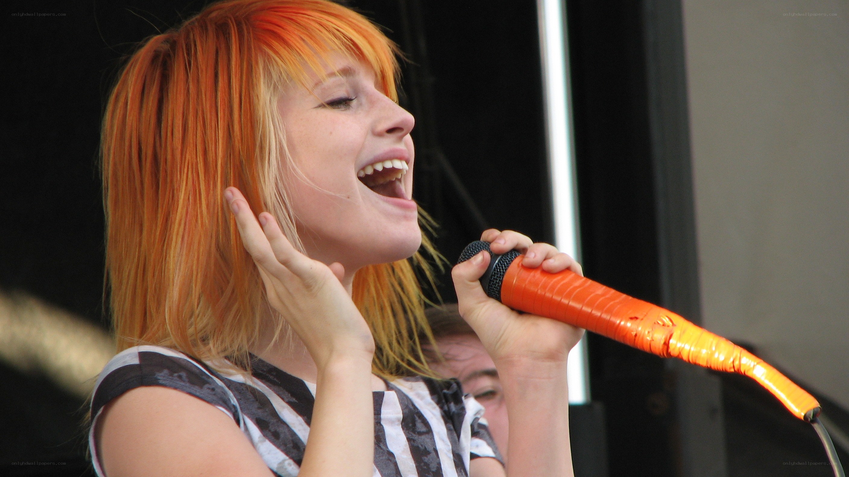 woman singing into microphone
