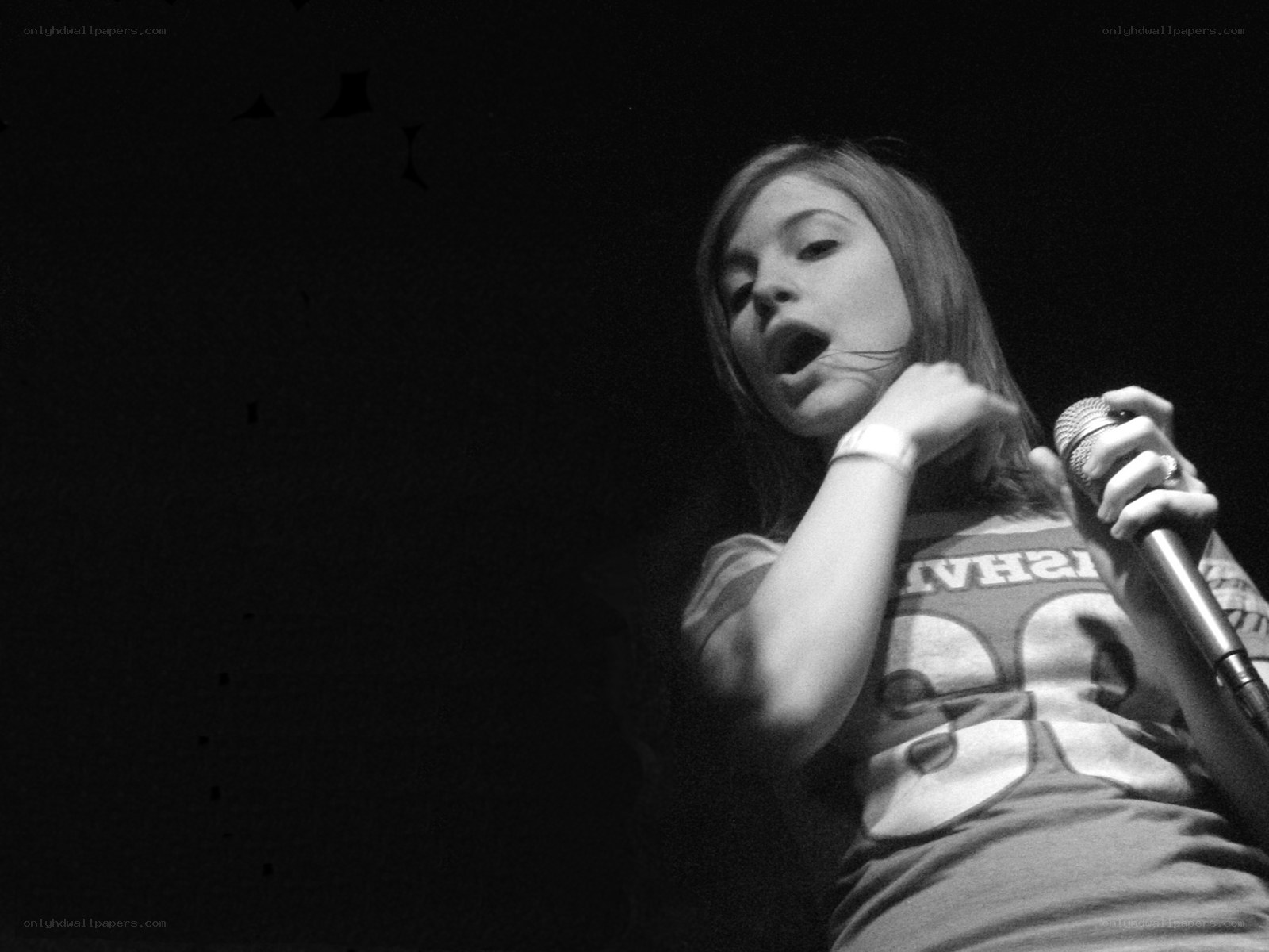 woman singing into microphone
