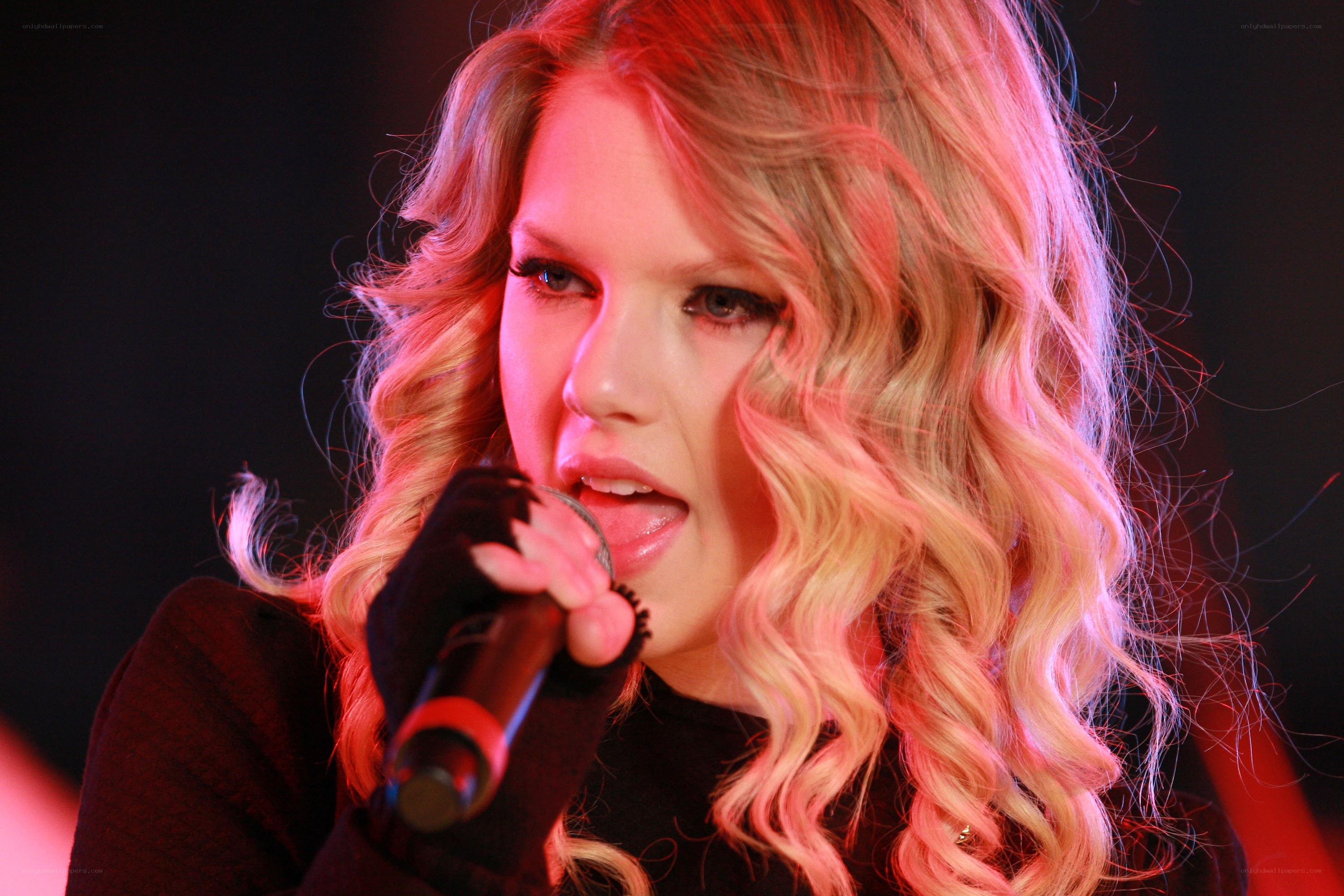 woman singing into microphone