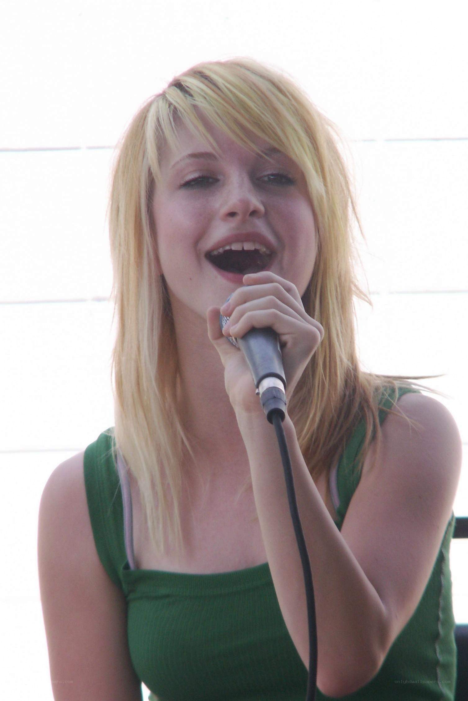 woman singing into microphone