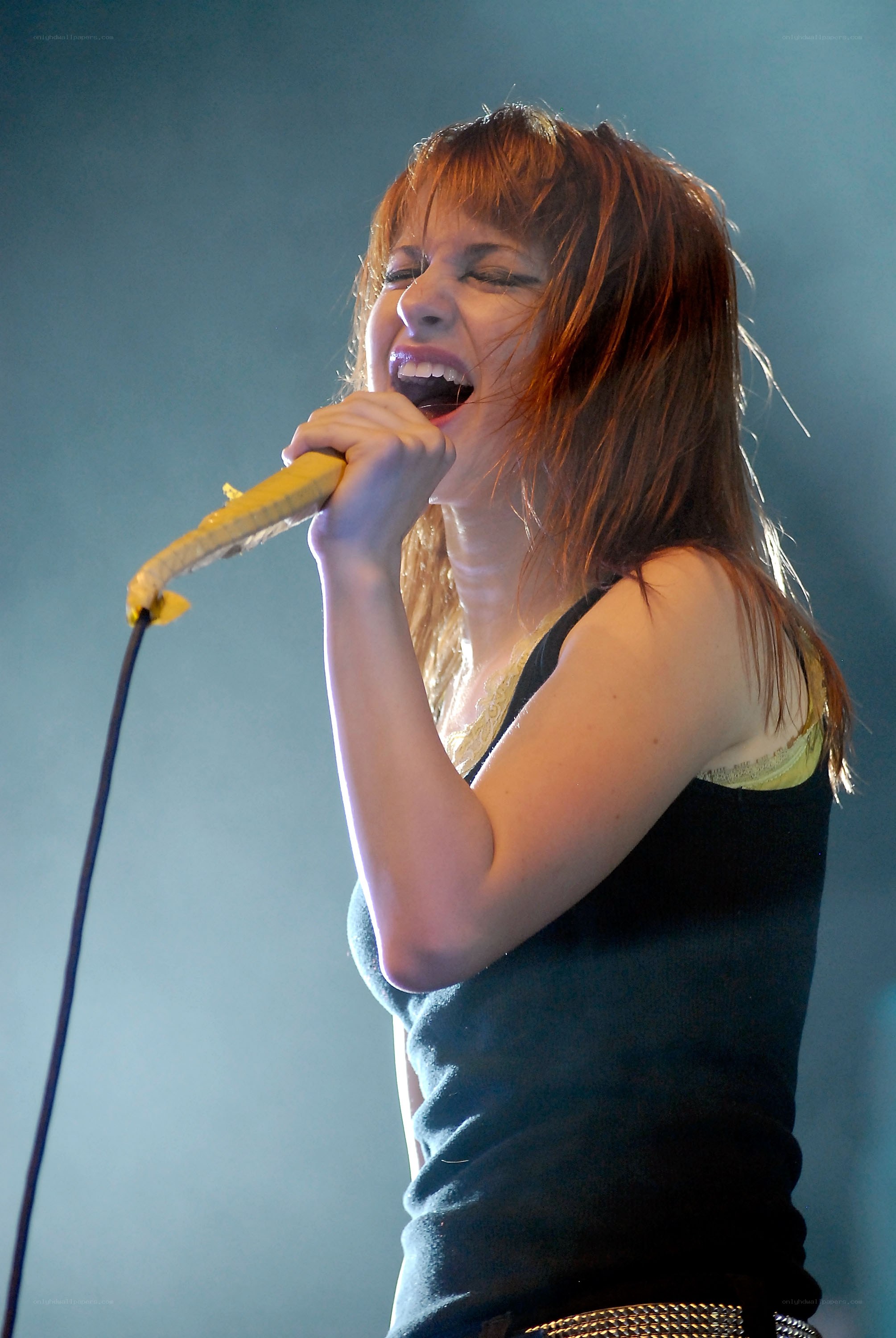 woman singing into microphone