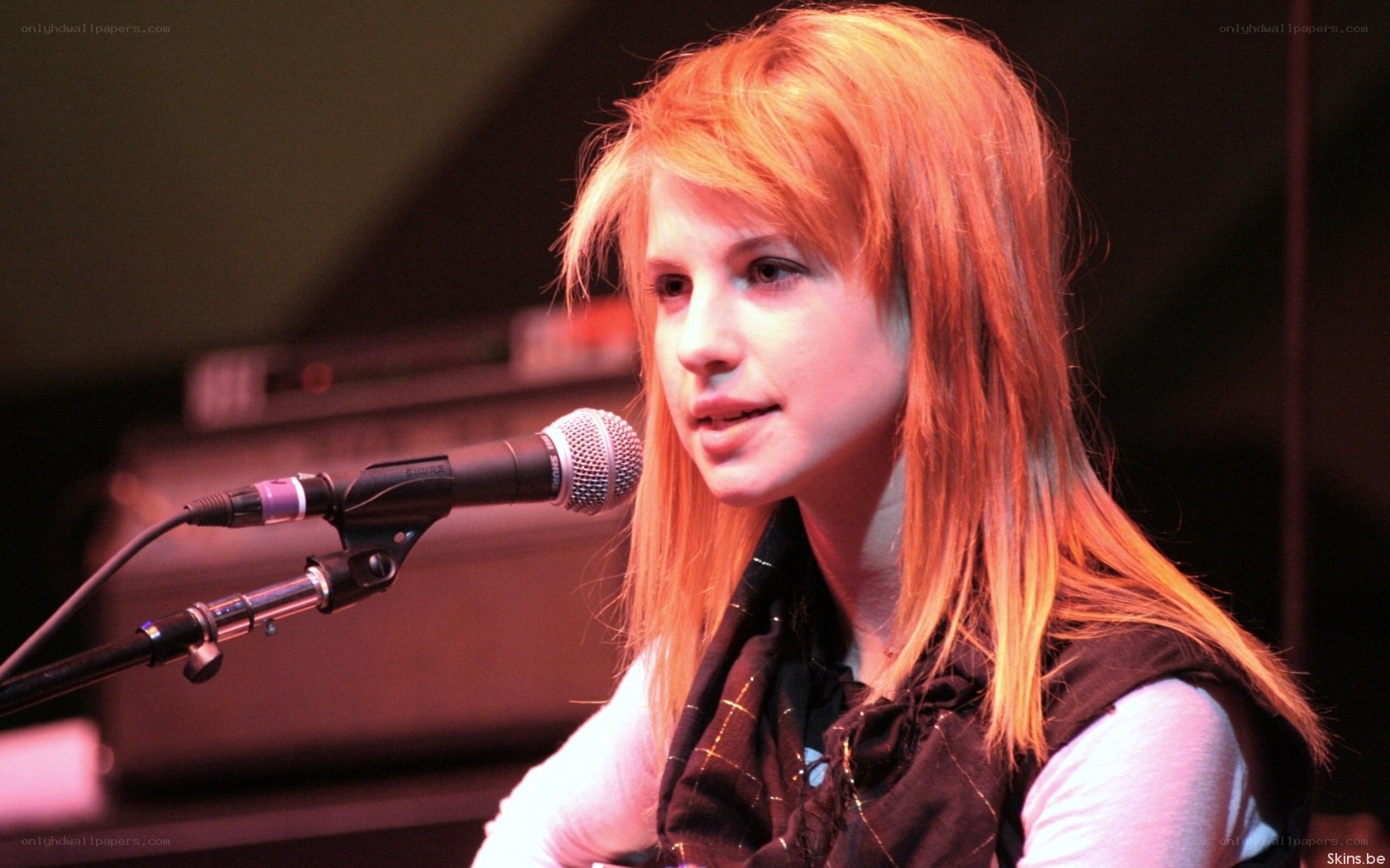 woman singing into microphone