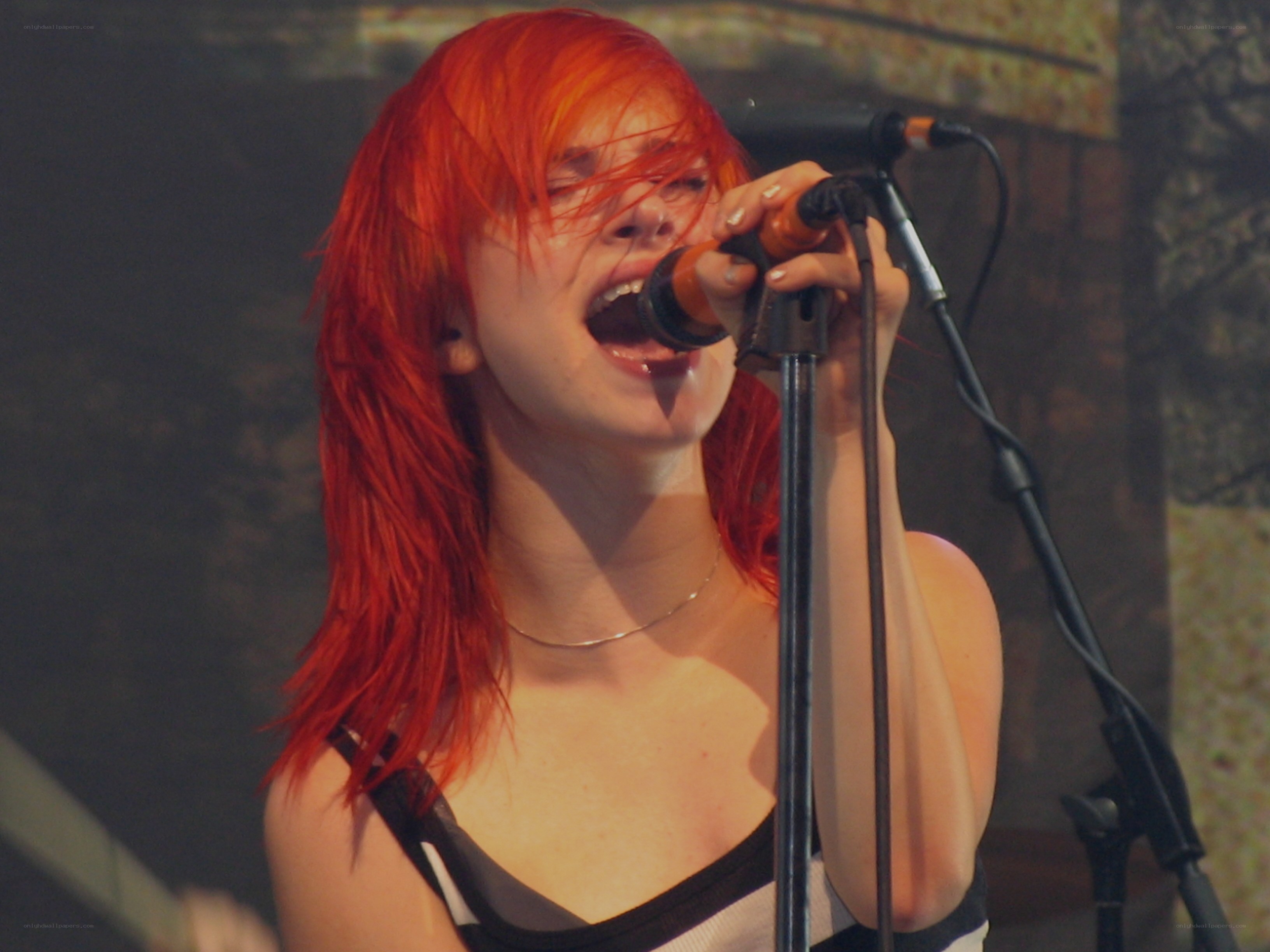 woman singing into microphone