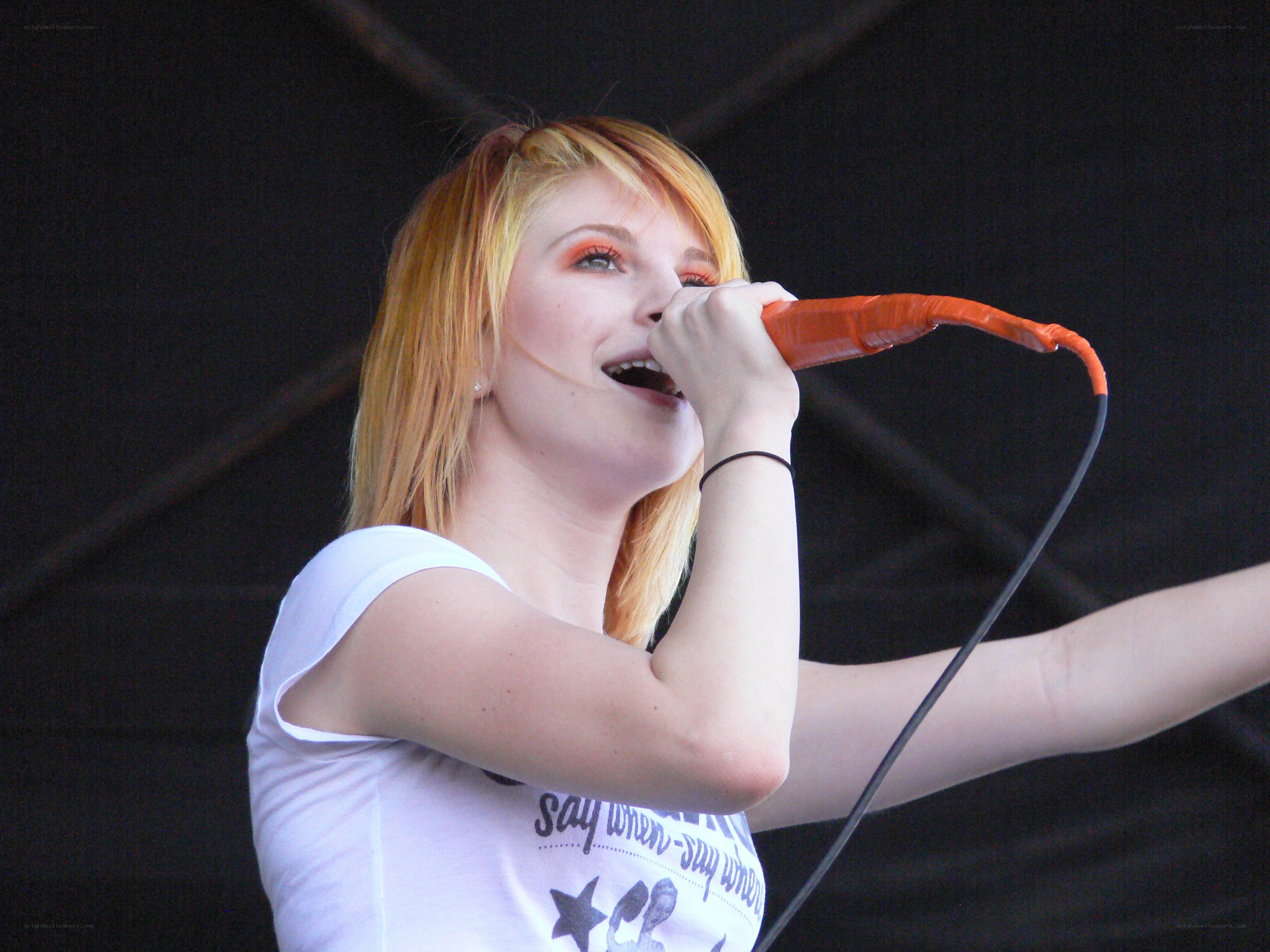 woman singing into microphone