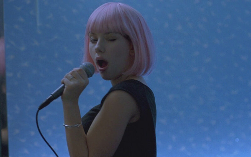 woman singing into microphone