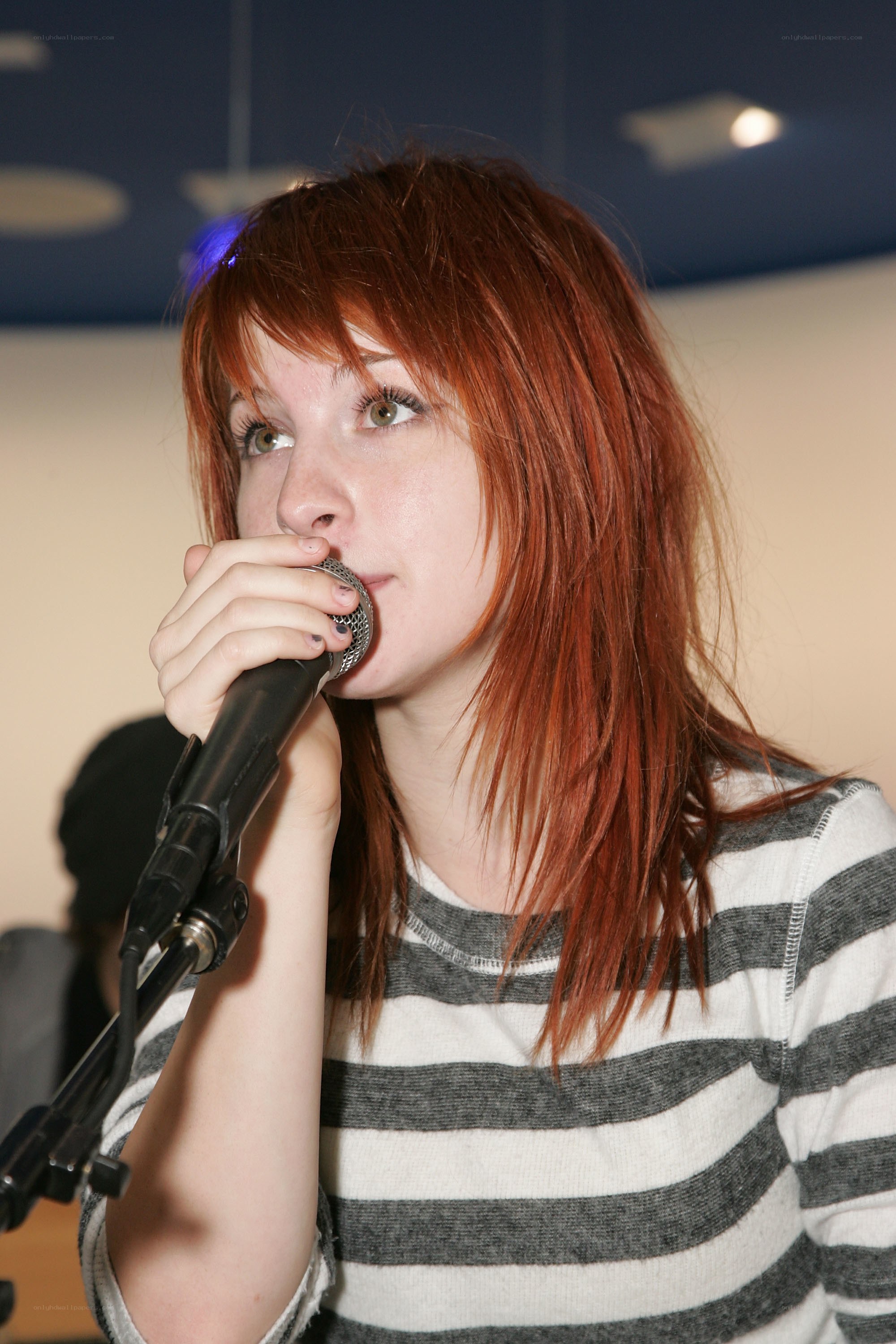 woman singing into microphone