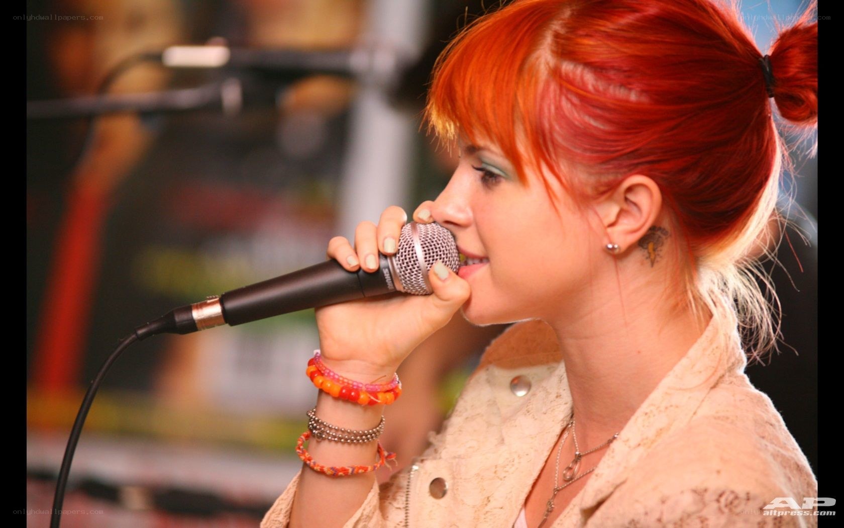 woman singing into microphone