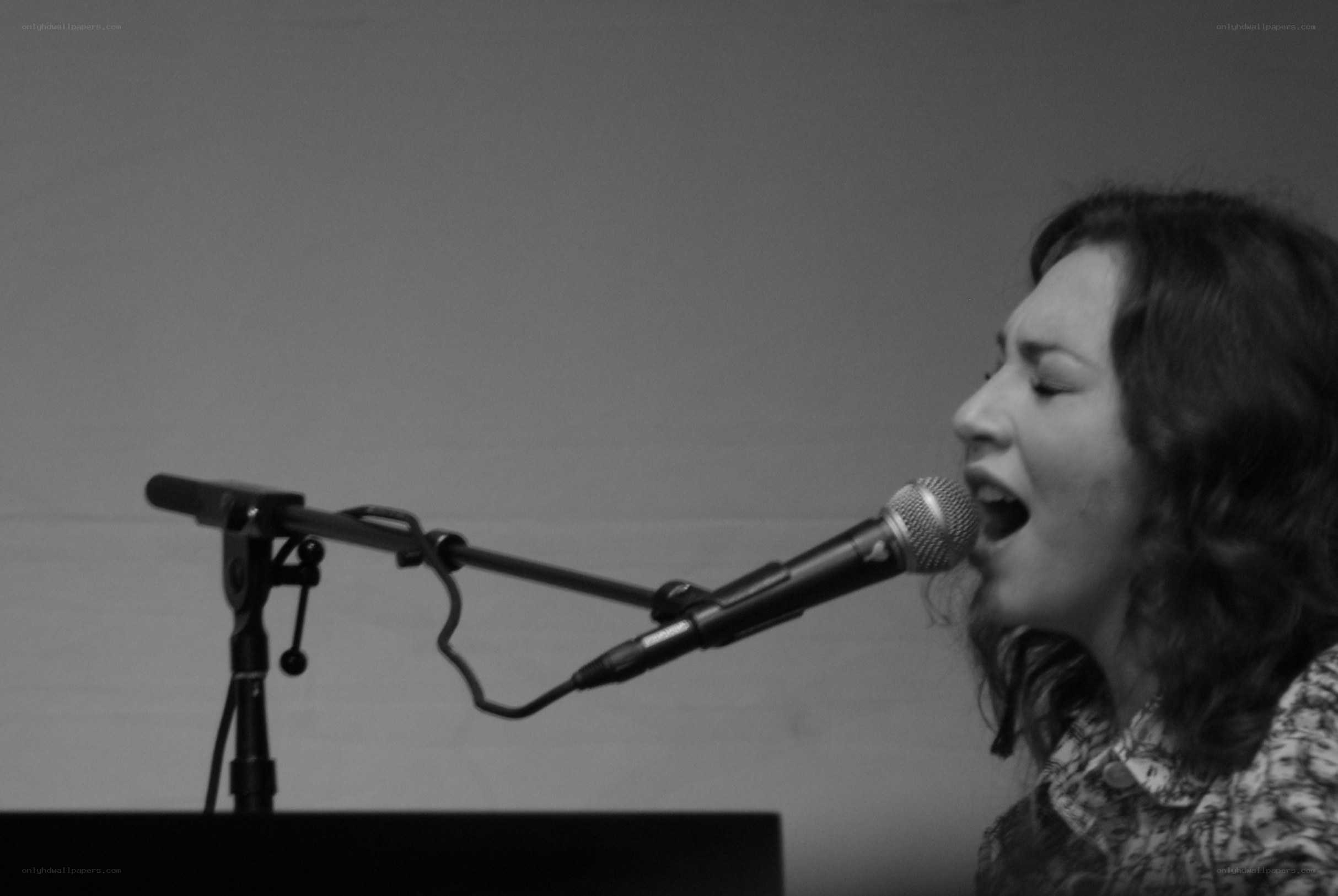 woman singing into microphone