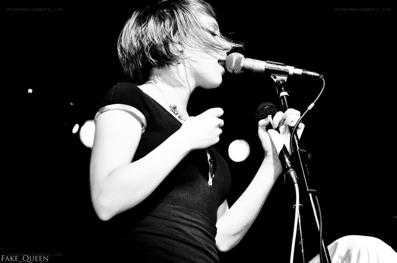 woman singing into microphone