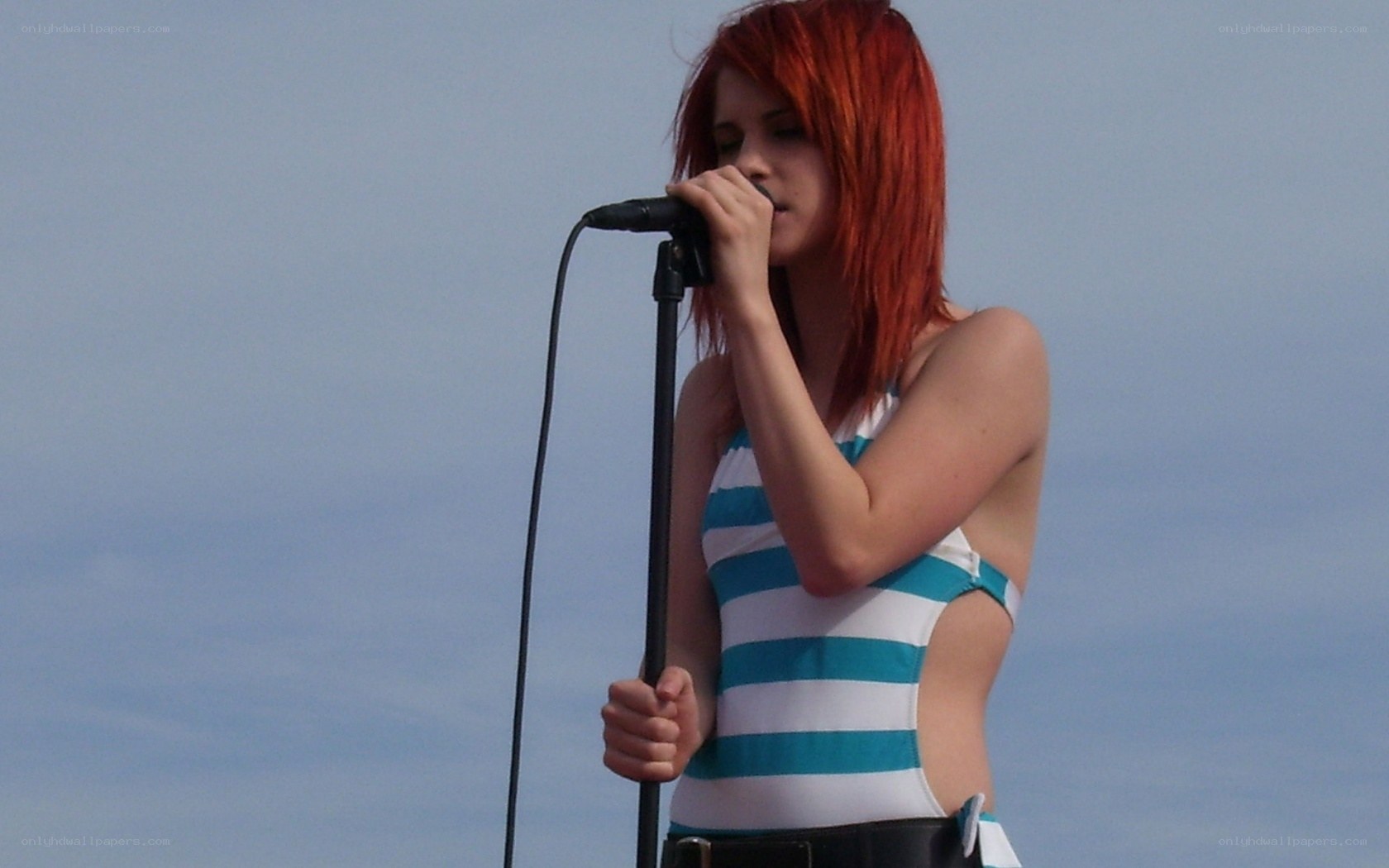 woman singing into microphone