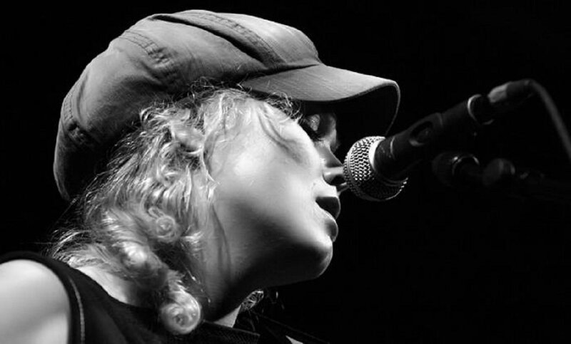 Woman Singing into Microphone — Black, Dramatic, Night, Photograph, Cap