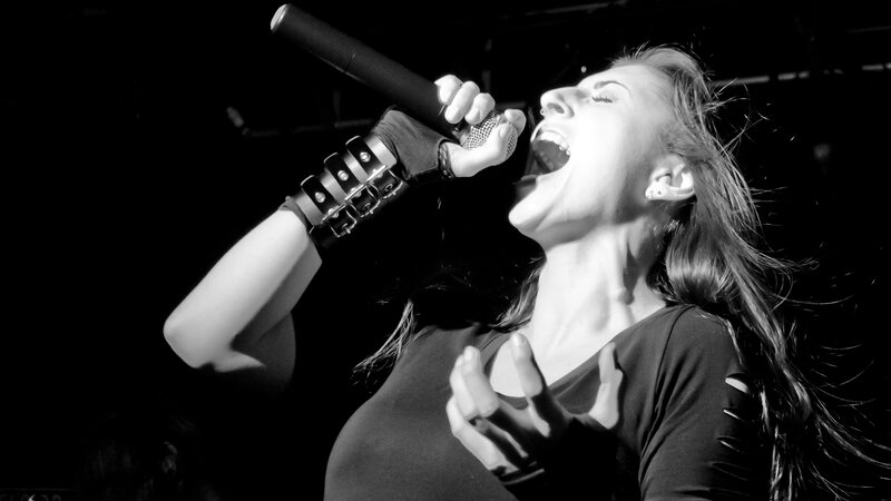 Woman Singing into Microphone — Black, Dramatic, Night, Photograph, Gloves, Earring