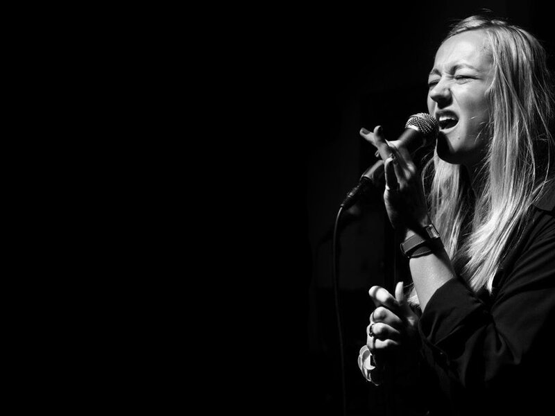 Woman Singing into Microphone — Black, Dramatic, Night, Photograph, Hand