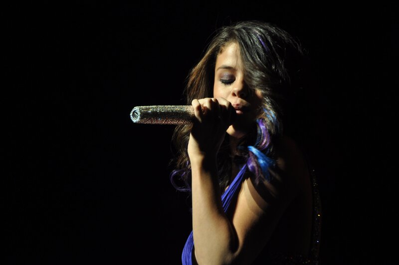 Woman Singing into Microphone — Black, Dramatic, Night, Photograph, Stage Light, Dress