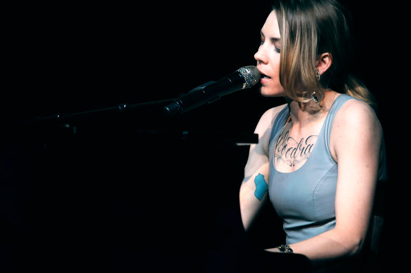 Woman Singing into Microphone — Black, Dramatic, Night, Photograph, Tattoo