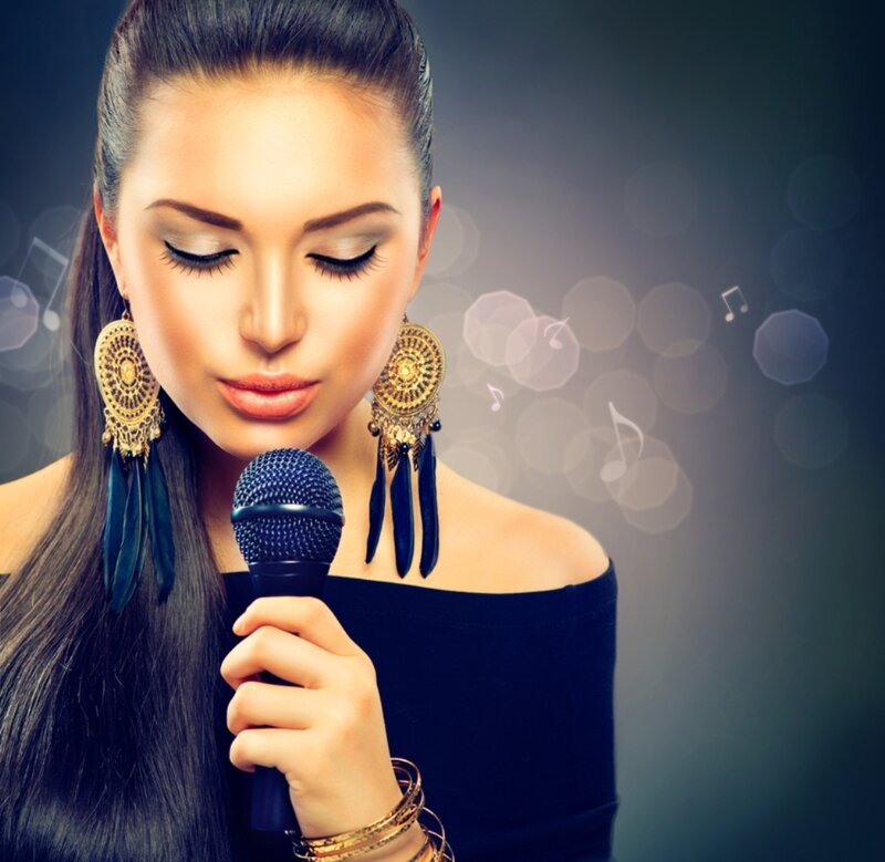 Woman Singing into Microphone — Black, Dramatic, Photograph, Earrings
