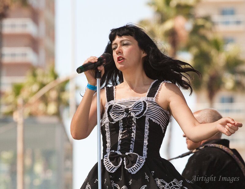 Woman Singing into Microphone — Black, Energetic, Afternoon, Photograph, Dress