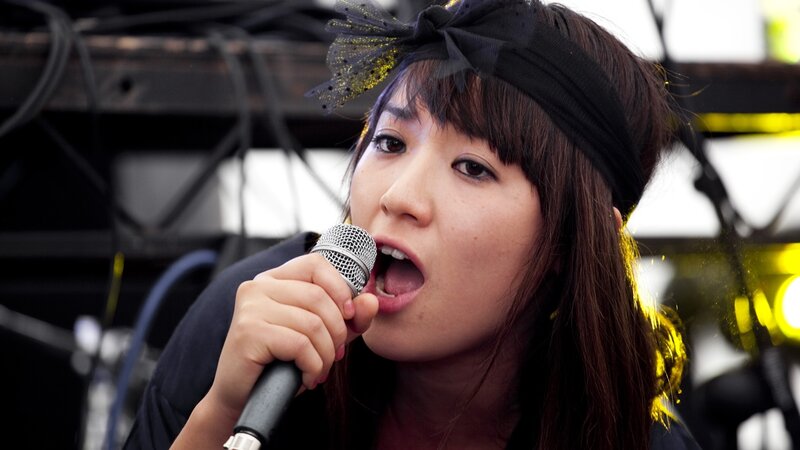 Woman Singing into Microphone — Black, Energetic, Afternoon, Photograph