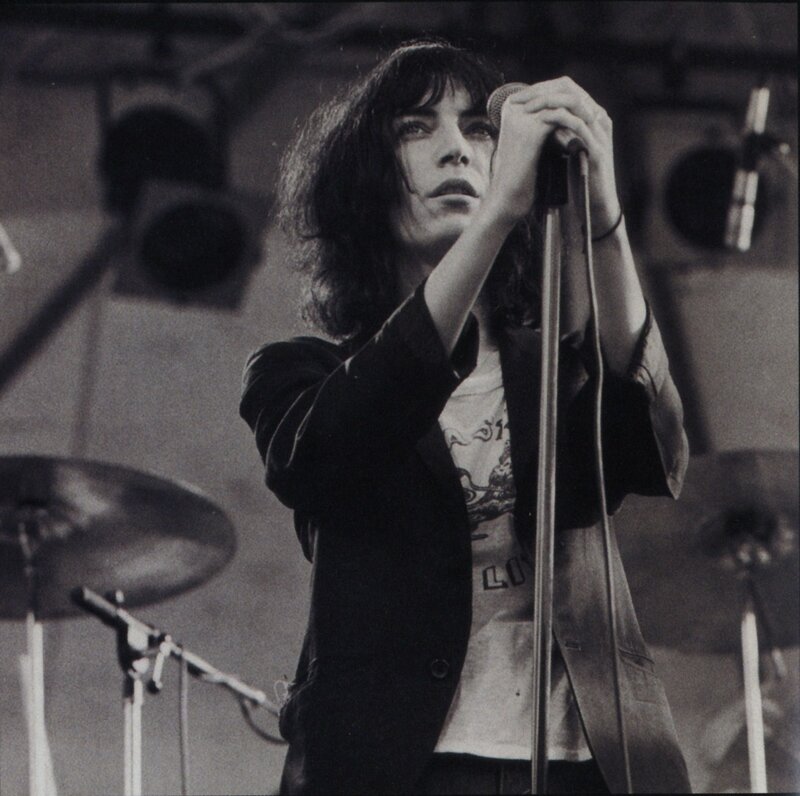 Woman Singing into Microphone — Black, Intense, Photograph, Drum Kit