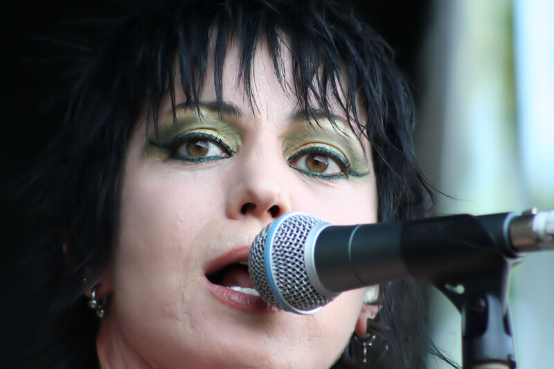 Woman Singing into Microphone — Black, Intense, Photograph