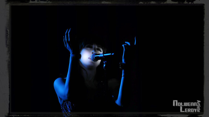 Woman Singing into Microphone — Blue, Dramatic, Night, Photograph, Hands